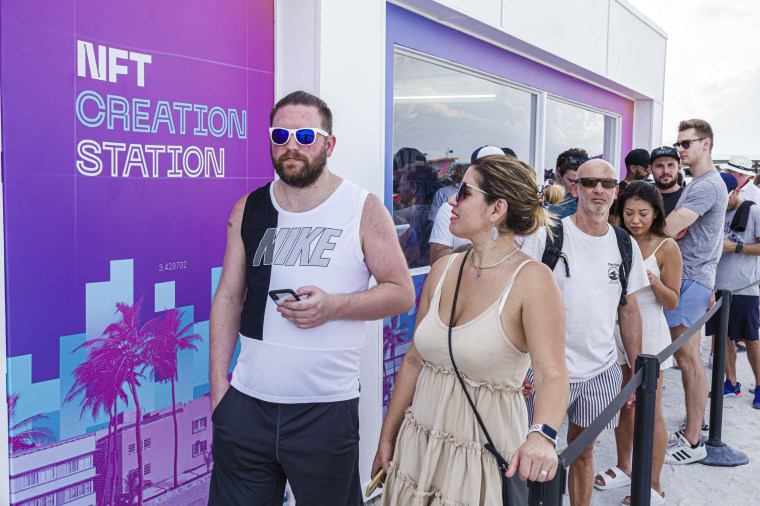 People stand in line to enter the "FTX Off the Grid" event