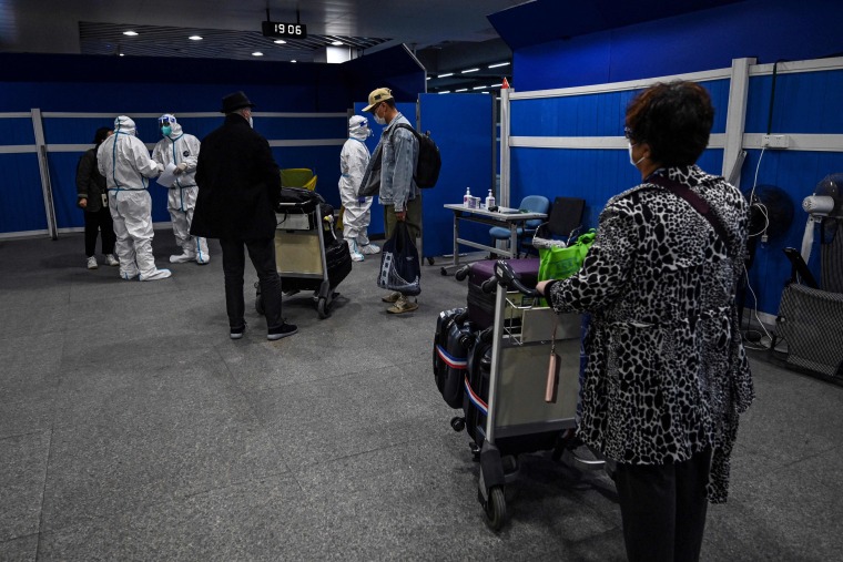 Inbound passengers are transported by bus to their quarantine hotels, after arriving at Pudong International Airport in Shanghai on Jan. 18, 2022.