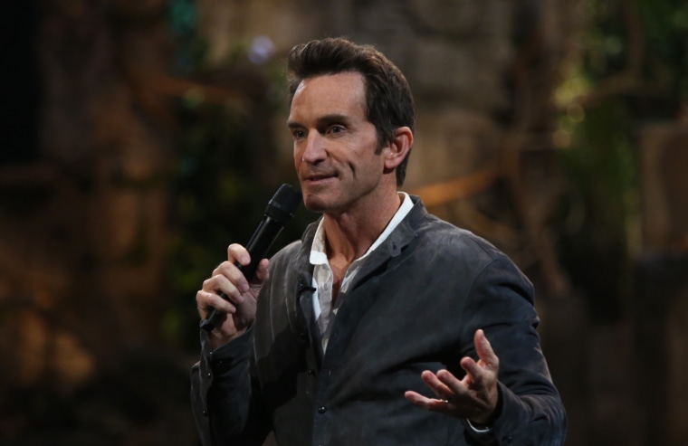 Jeff Probst holding a microphone.