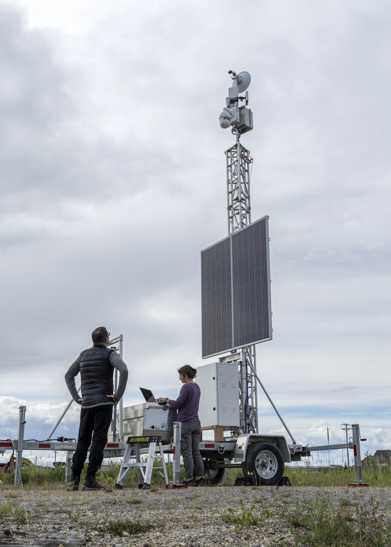 Geoff York and KT Miller install a mobile radar tower in Churchill, Manitoba, in Canada.