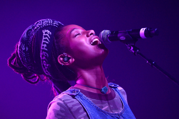 Willow Smith singing into a microphone.