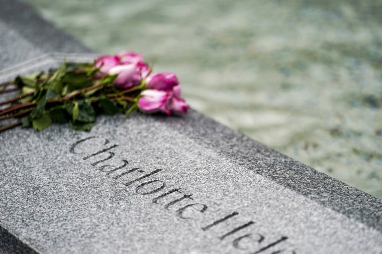 Flowers lay next to the name of Charlotte Bacon, carved in the stone of a memorial dedicated to the victims of the Sandy Hook Elementary School shooting, in Newtown, Conn., on Nov. 13, 2022.