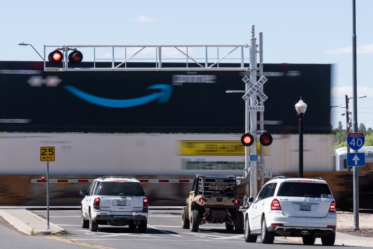 A BNSF freight train travels across a railroad crossing