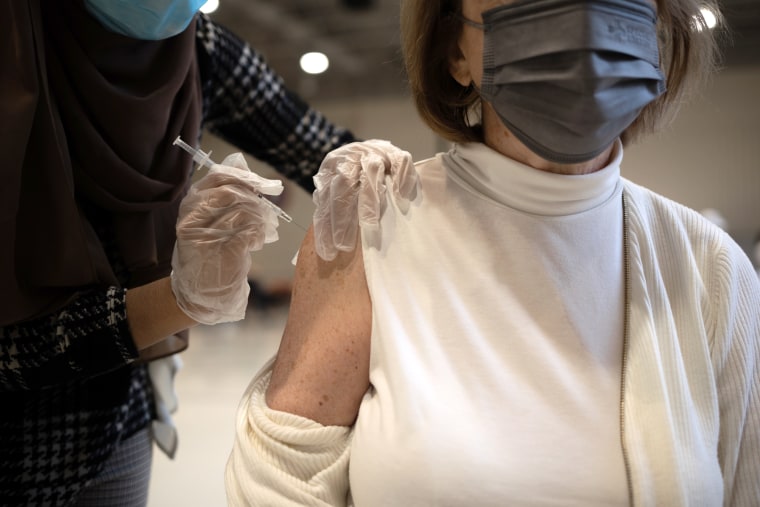 A patient receives a Covid-19 booster shot at a vaccine clinic inside Trinity Evangelic Lutheran Church in Lansdale, Pennsylvania.