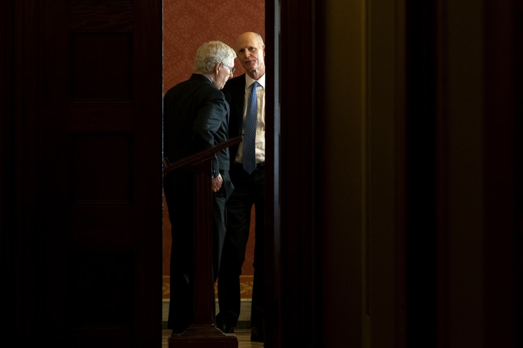 Senate Minority Leader Mitch McConnell, speaks to Sen. Rick Scott, R-Fla., during a Republican caucus meeting at the Capitol on  Oct. 7, 2021.