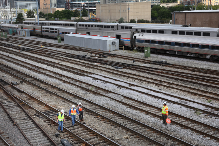 Workers service the tracks at the Metra/BNSF railroad yard in Chicago 