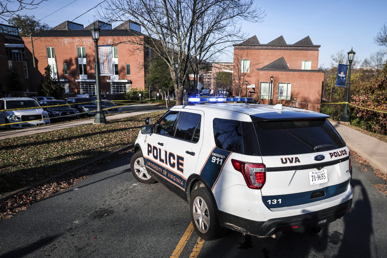 Image: A law enforcement blocks access to the crime scene where 3 people were killed and 2 others wounded on the grounds of the University of Virginia on Nov. 14, 2022 in Charlottesville, Va.