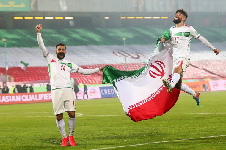 Saman Ghoddos, left, and Ali Gholizadeh of Iran celebrate after the FIFA World Cup Qualifier match between Iran and Iraq at Azadi Stadium in Tehran, Iran, on Jan. 27, 2022.