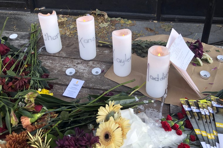 Candles and flowers are left at a make-shift memorial honoring four slain University of Idaho students outside the Mad Greek restaurant in downtown Moscow, Idaho, on Tuesday, Nov. 15, 2022. Police discovered the bodies of the four students at home near campus on Sunday, Nov. 13, 2022, and said the killer or killers used a knife or bladed weapon in the targeted attack. Two of the victims, 21-year-old Madison Mogen and 20-year-old Xana Kernodle, were servers at Mad Greek.