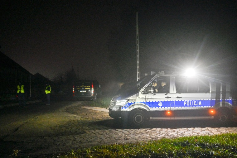 PRZEWODOW, POLAND - NOVEMBER 16: Police vans stand by a check point as permitted cars are allowed to cross into the crime scene on November 16, 2022 in Przewodow, Poland. Poland convened a meeting of its national security council amid reports that stray missiles hit its territory, killing two people. Russia's defense ministry denied that its missiles hit the NATO member state, but moments after, Polish ministry confirmed it was a Russian-produced missile. (Photo by Omar Marques/Getty Images)