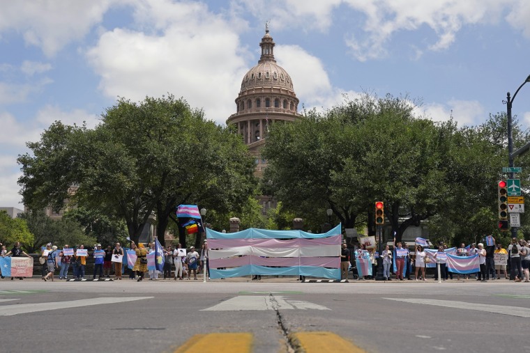 Demonstrators gather on the steps of the Texas State Capitol to speak against transgender-related legislation bills being considered on May 20, 2021, in Austin.