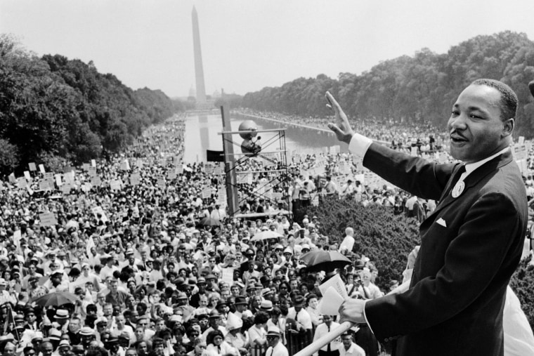 Martin Luther King Jr. waves to supporters on the Mall during the "March on Washington" on Aug. 28, 1963. 