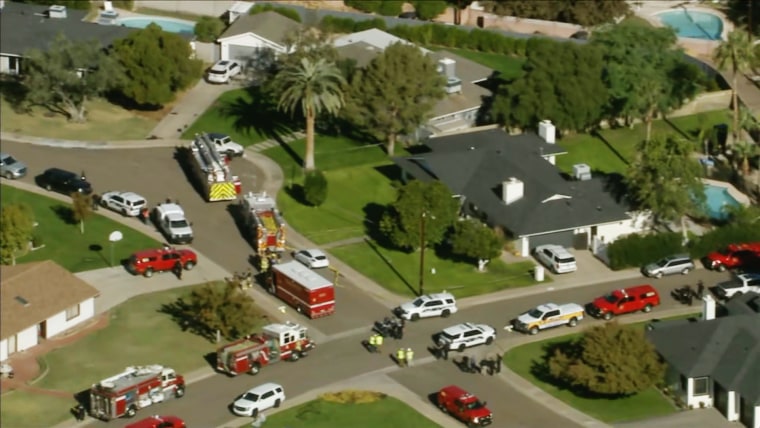 Emergency vehicles near the home where multiple were found dead in Phoenix on Nov. 16, 2022.
