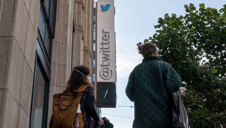 Pedestrians pass Twitter headquarters in San Francisco, Calif., on Oct. 6, 2022. 