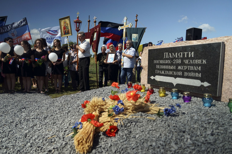 People attend a memorial service at the crash site of the Malaysia Airlines Flight MH17, near the village of Hrabove, Ukrain