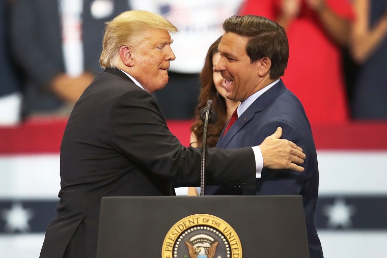 President Donald Trump greets Florida Republican gubernatorial candidate Ron DeSantis during a campaign rally at the Hertz Arena on October 31, 2018 in Estero, Florida. President Trump continues traveling across America to help get the vote out for Republican candidates running for office.