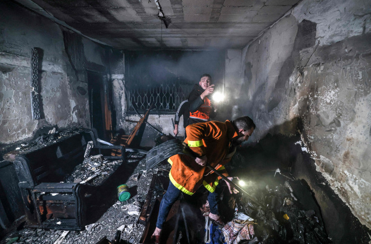 Firefighters extinguish flames in an apartment ravaged by fire in the Jabalia refugee camp in the northern Gaza strip, on Nov. 17, 2022.