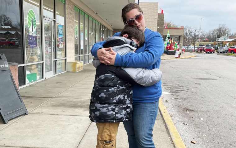 Anthony and Autumn Janeway hug at a shopping plaza