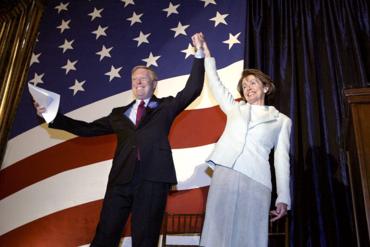 Dick Gephardt raises the arm of Nancy Pelosi after a ceremonial swearing in, on Jan. 7, 2003, in Washington