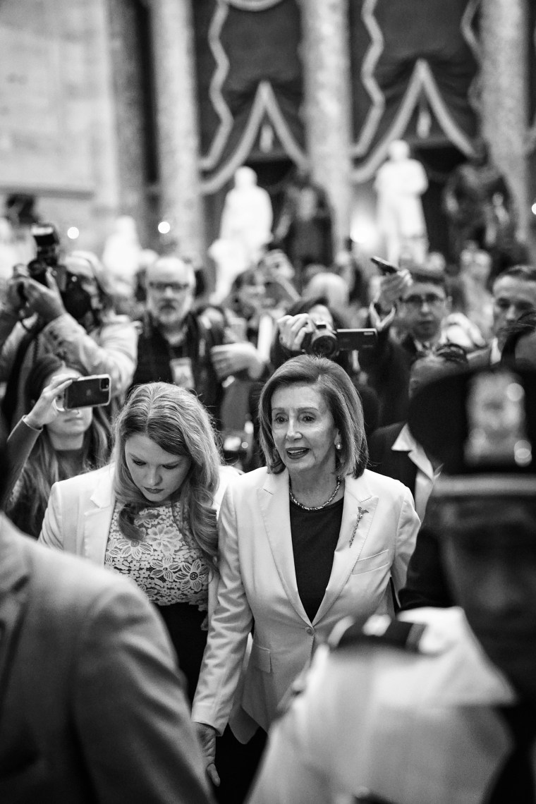 Surrounded by staff, security and journalists, Speaker of the House Nancy Pelosi, D-Calif., walks out of the House Chamber after announcing she would not be the Democratic leader in the 118th Congress at the U.S. Capitol on Nov. 17, 2022.