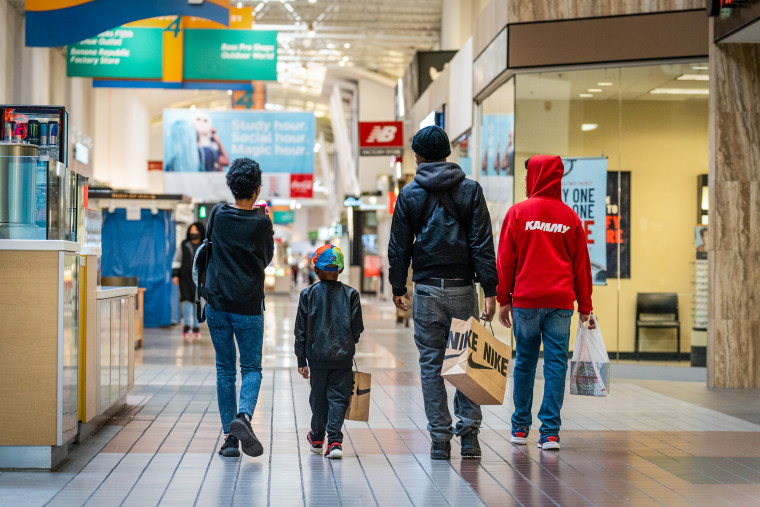Customers carry shopping bags at a shopping mall in Anne Arundel, Md., on Nov. 9, 2022. 