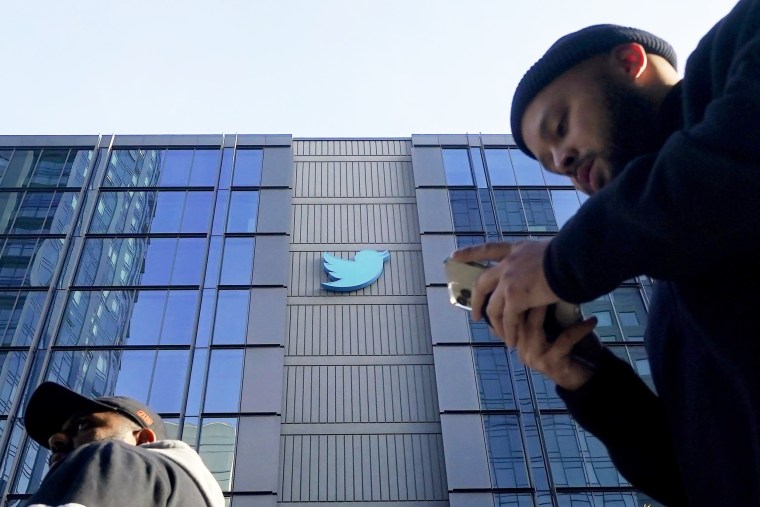 People walk outside Twitter headquarters in San Francisco