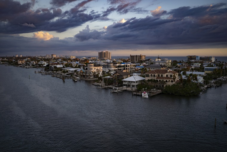 A view of the Matanzas Pass side of Estero Island, home to Fort Myers Beach, which can be seen on the far side under the clouds, one month after Hurricane Ian ravaged the area.