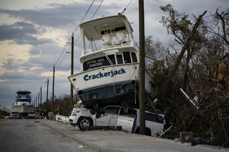 A charter boat sits on top of a SUV on Oct. 31, a month after Hurricane Ian ravaged Fort Myers Beach, Fla.
