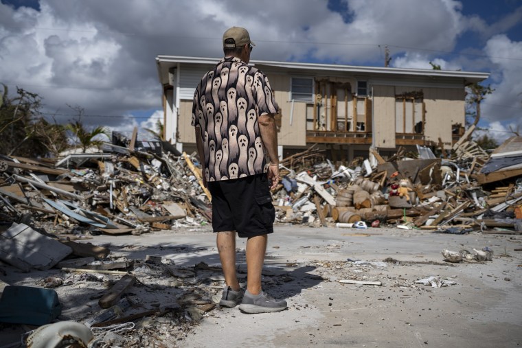 Michael Yost at the damaged home he was renting on Fort Myers Beach, Fla. one month after Hurricane Ian ravaged the area.