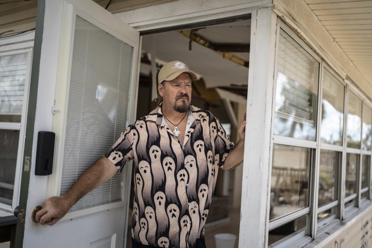 Michael Yost at the damaged home he was renting on Fort Myers Beach, Fla.