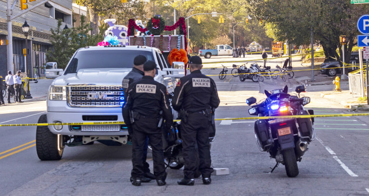 Police officers work the scene of a fatal accident at a holiday parade