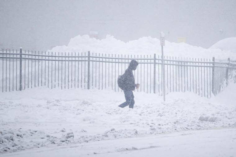 A man walks through the snow in Buffalo, New York