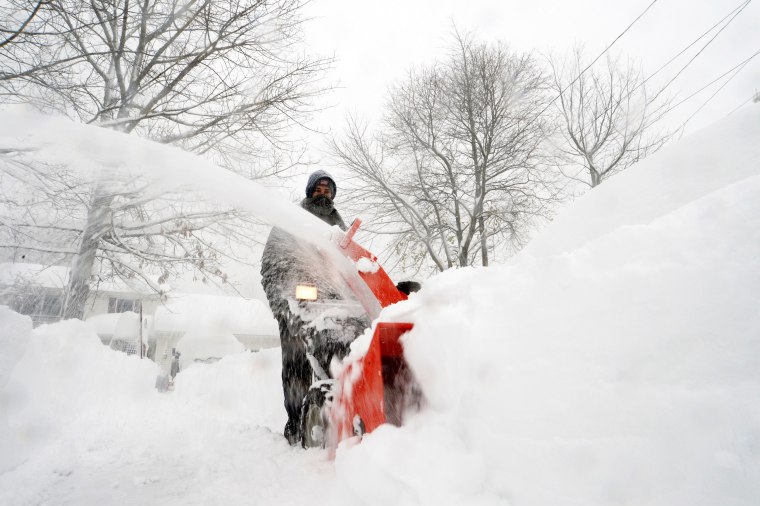 A antheral   uses a snowblower to wide   snowfall  successful  Hamburg, N.Y.