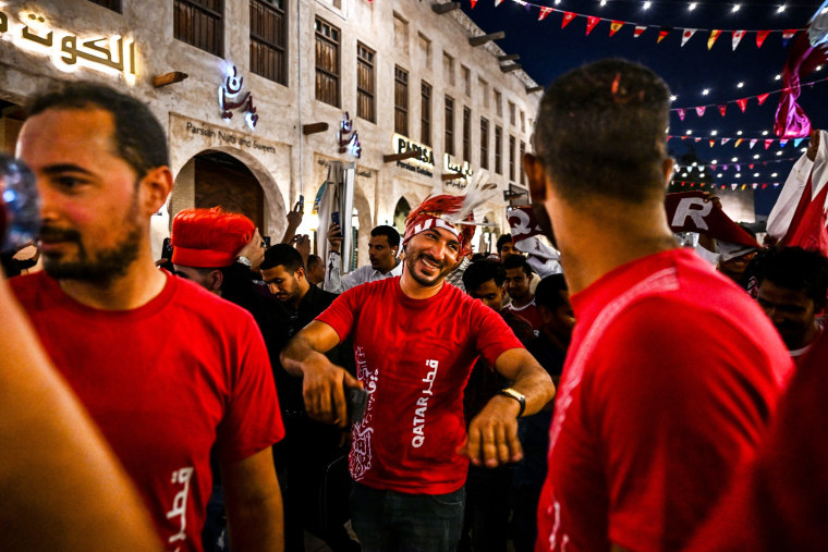 People dance at the Souq Waqif marketplace ahead of the FIFA World Cup