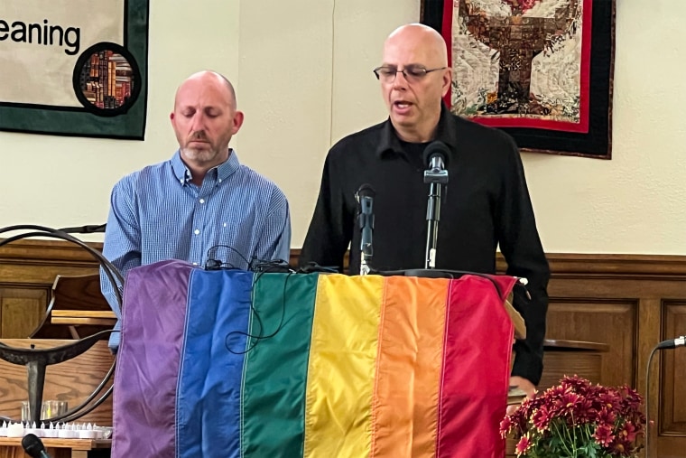 Club Q owners Nic Grzecka and Matthew Haynes speak at a vigil at All Souls Unitarian Church in Colorado Springs, Colo., on Nov. 20, 2022.
