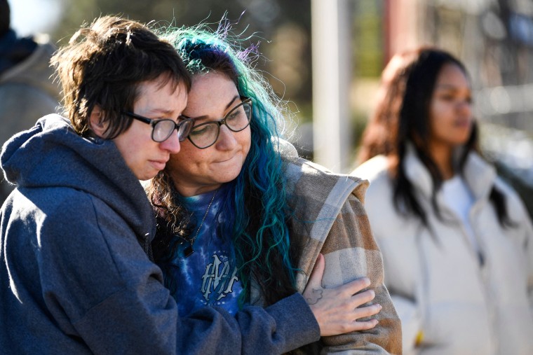 Jessy Smith Cruz embraces Jadzia Dax McClendon the morning after a mass shooting at Club Q, an LGBTQ nightclub in Colorado Springs, Colo.,, on Nov. 20, 2022.