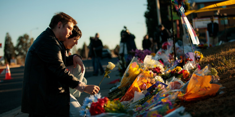 Image: People leave flowers at the growing memorial near the shooting scene inside Club Q in Colorado Springs, Colorado.
