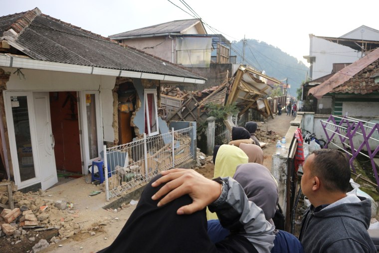 Residents react as they inspect houses damaged by Monday's earthquake in Cianjur, West Java, Indonesia Tuesday, Nov. 22, 2022. The earthquake has toppled buildings on Indonesia's densely populated main island, killing a number of people and injuring hundreds.