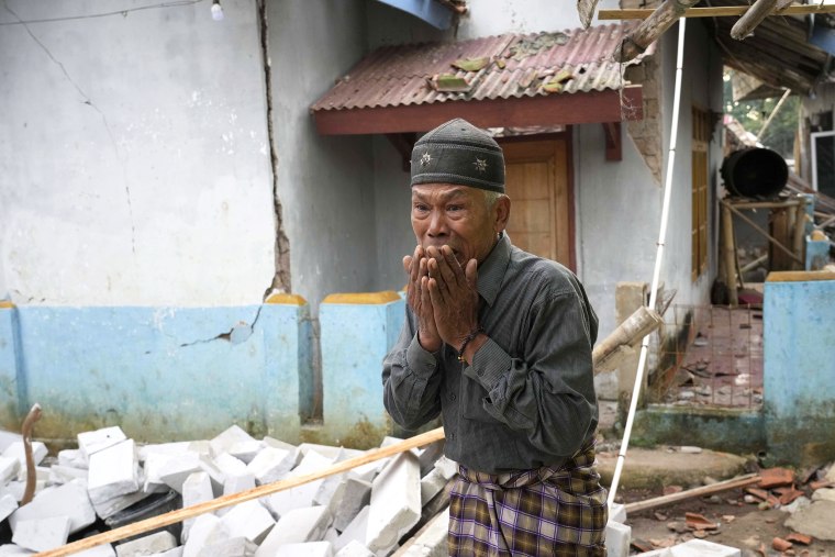 A man reacts as he inspects the damage caused by Monday's earthquake in Cianjur, West Java, Indonesia Tuesday, Nov. 22, 2022. The earthquake has toppled buildings on Indonesia's densely populated main island, killing a number of people and injuring hundreds.