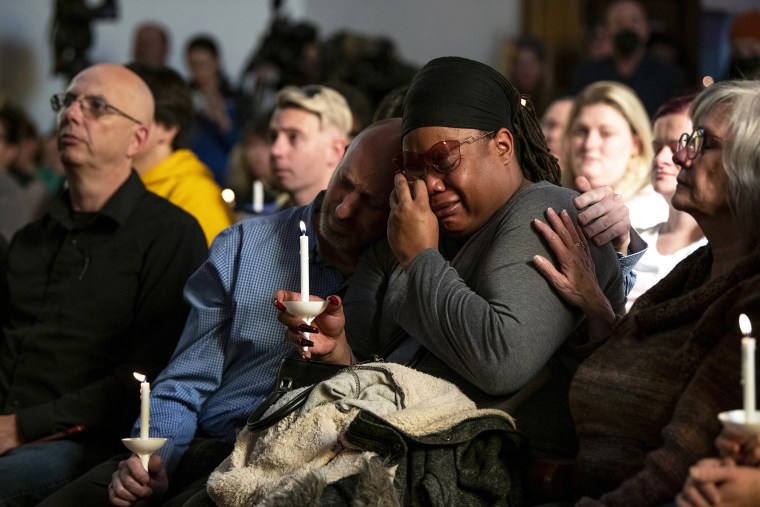 Tyrice Kelley, center right, an artist with Club Q, is comforted during a service at All Souls Unitarian Church in Colorado Springs on November 20, 2022. 