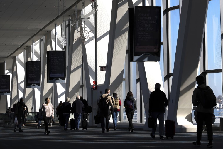 Travelers walk through LaGuardia Airport's Terminal B, on Nov. 22, 2022, in New York.