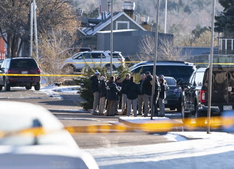 Law enforcement personnel stand outside Club Q 