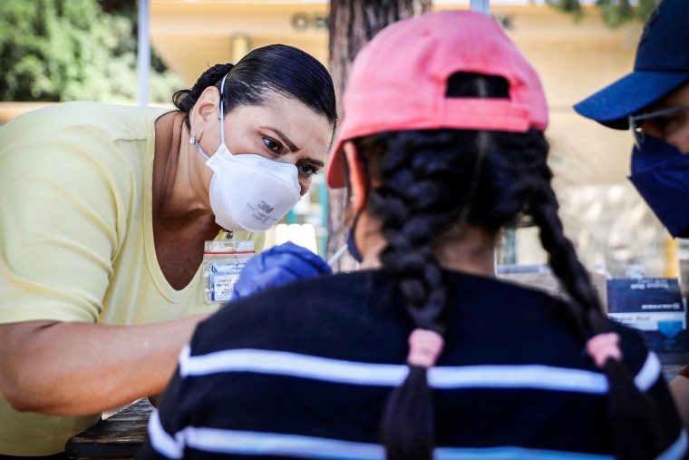 A medical worker collects a swab sample from a resident for a Covid-19 test in Los Angeles on Aug. 5, 2022.