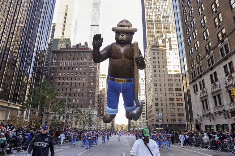 Handlers pull the Smokey Bear balloon down Sixth Avenue, a regular fixture during the Macy's Thanksgiving Day Parade.