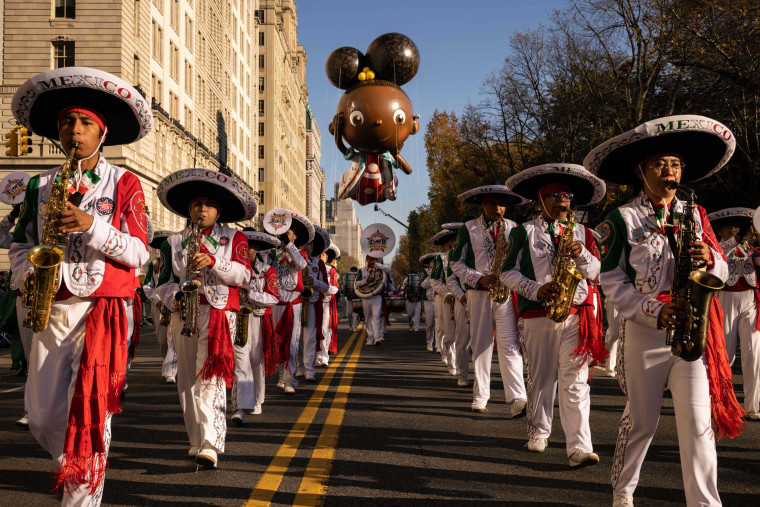 A Mexican marching band leads the Ada Twist, Scientist balloon.