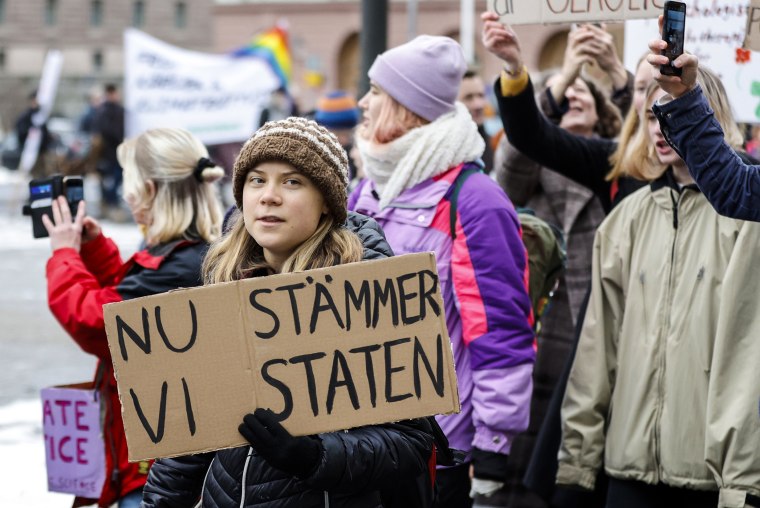 Image: Climate activist Greta Thunberg attends a demonstration by youth-led organization Auroras, in Stockholm, Sweden, on Nov. 25, 2022. Writing on cardboard reads in Swedish "Now we sue the State."