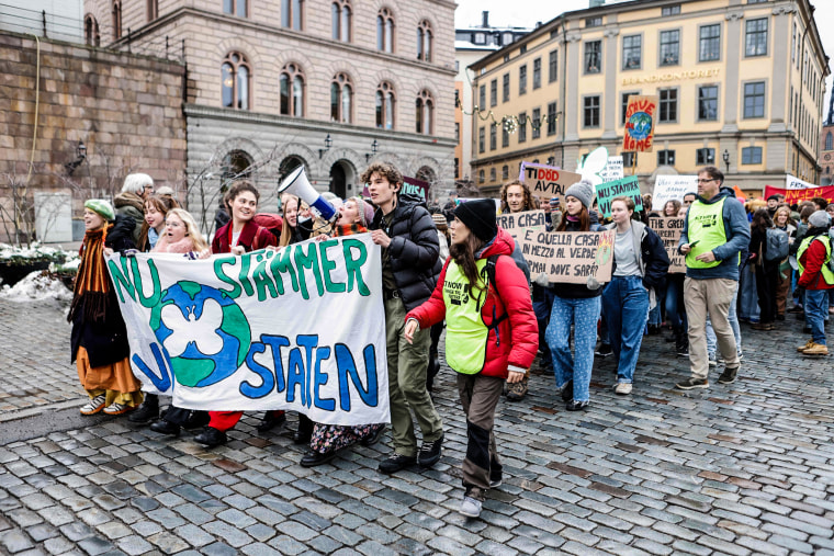 Image: Participants march during a climate demonstration called by youth-led organization Auroras before it submitted its lawsuit against the state for their lack of climate work, in Stockholm on Nov. 25, 2022.