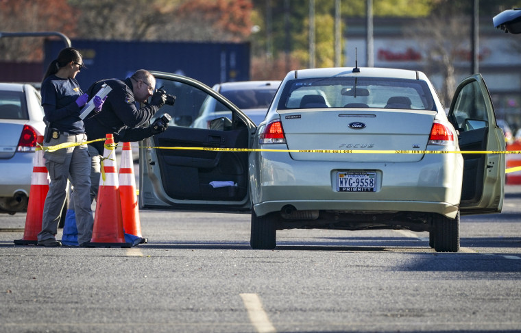 Investigators document the vehicle owned by the shooter outside a Walmart Supercenter where six people, including the shooter, were shot and killed on Nov. 23, 2022 in Chesapeake, Va.