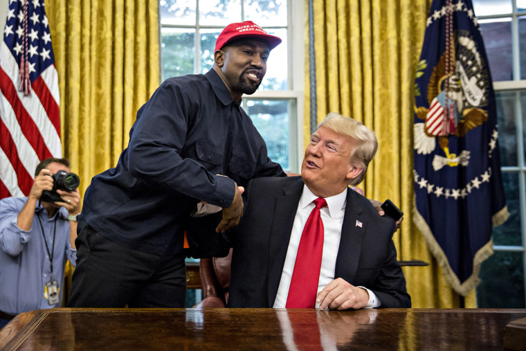 Rapper Kanye West, left, shakes hands with Then-President Donald Trump during a meeting in the Oval Office of the White House on Oct. 11, 2018.
