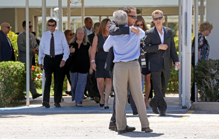 Mourners exit a memorial service for John Stevens and Michelle Mishcon Stevens